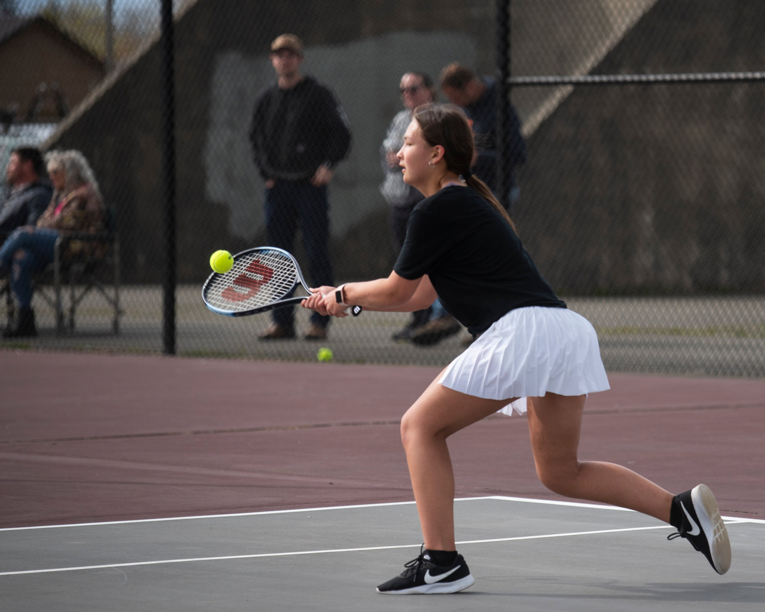 Centralia third singles player Maya Lackie hits a backhand during a match at W.F. West on Friday.