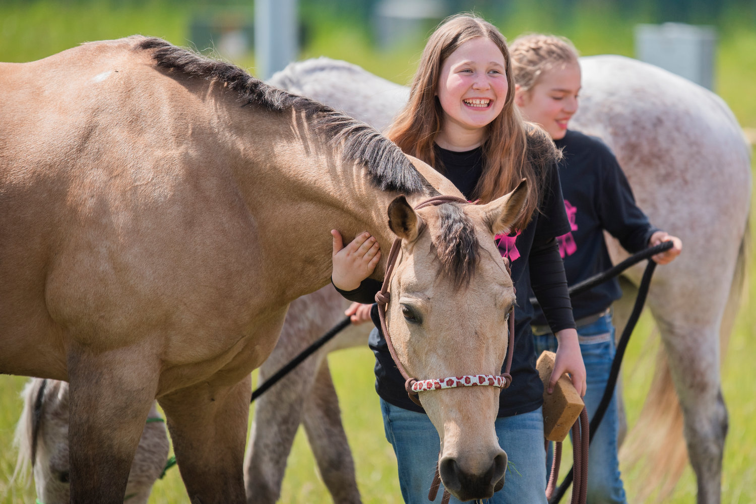 Rikki Workman smiles as she pets and cleans her horse, Butter, at the Southwest Washington Fairgrounds alongside Bristol Osborn and her horse Annie while describing the arena as a “swamp” on Sunday. Friday marked the return of the Spring Youth Fair, which was canceled the two previous years due to COVID-19. The Spring Youth Fair is essentially a smaller version of the Southwest Washington Fair that focuses on children. Look for information on next year’s run online at springyouthfair.org.
