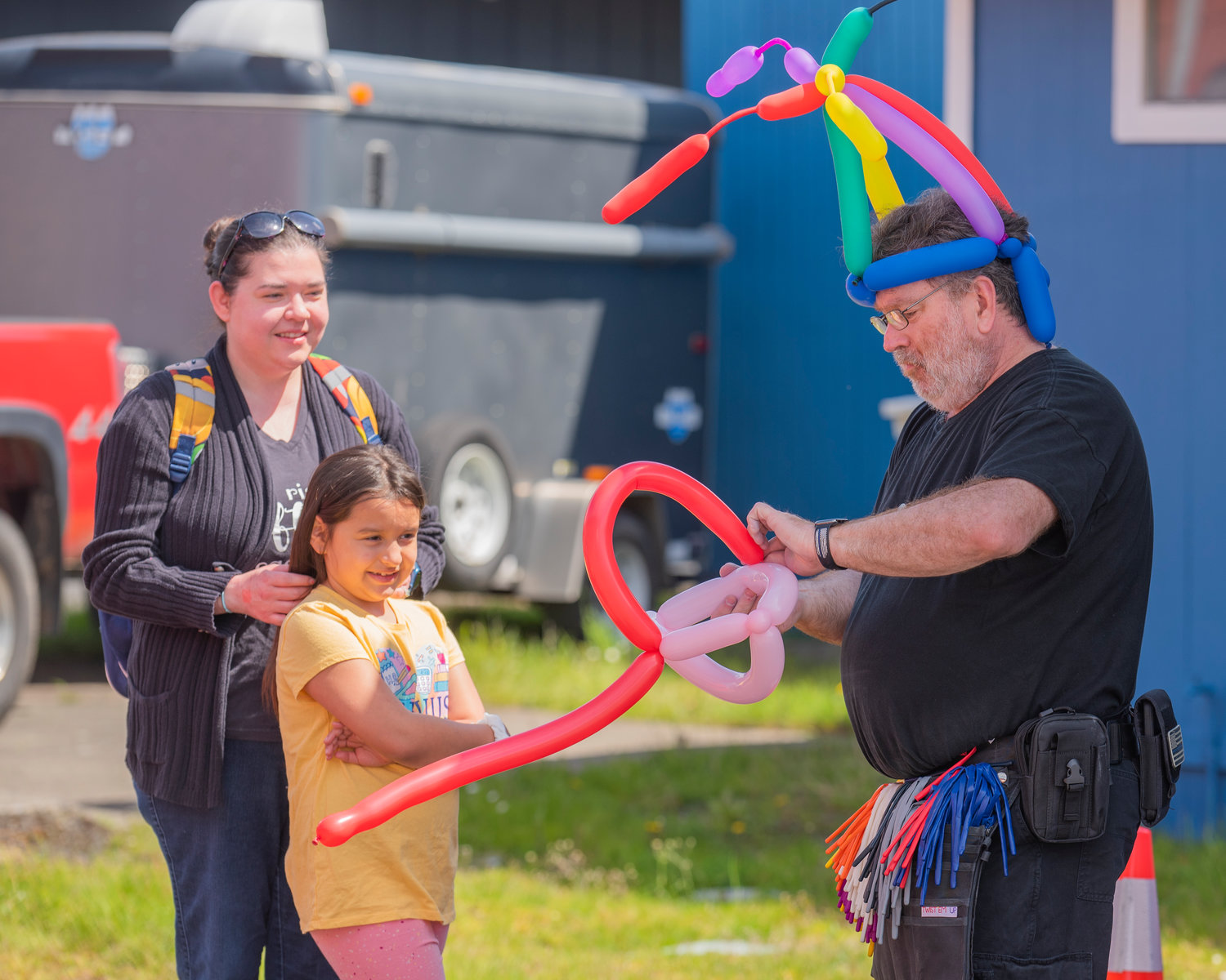 Balloon hats are bent into shape for visitors at the Spring Youth Fair in Centralia on Sunday.