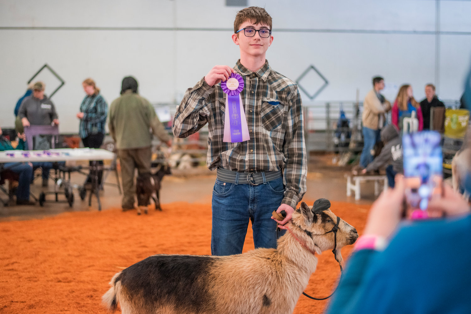 Will Allen, 14, poses for a photo while holding up his Grand Champion ribbon alongside his Nigerian Dwarf goat named Oreo on Saturday during the Spring Youth Fair in Centralia.