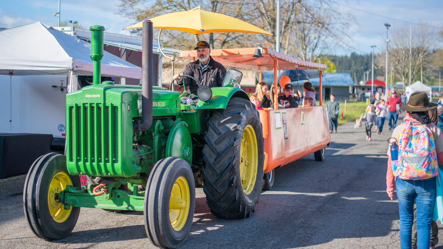Dave King drives a tractor full of visitors through the Southwest Washington Fairgrounds in Centralia on Saturday.