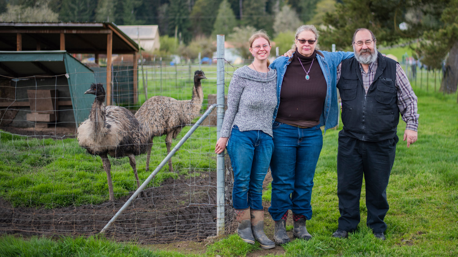 From left, Emily Polkinghorn, her mother Janean Parker and step-father Tony Citrhyn pose for a photo with their emus Kate and Kronos Friday at 3 Feathers Emu Ranch and Farm in Adna.
