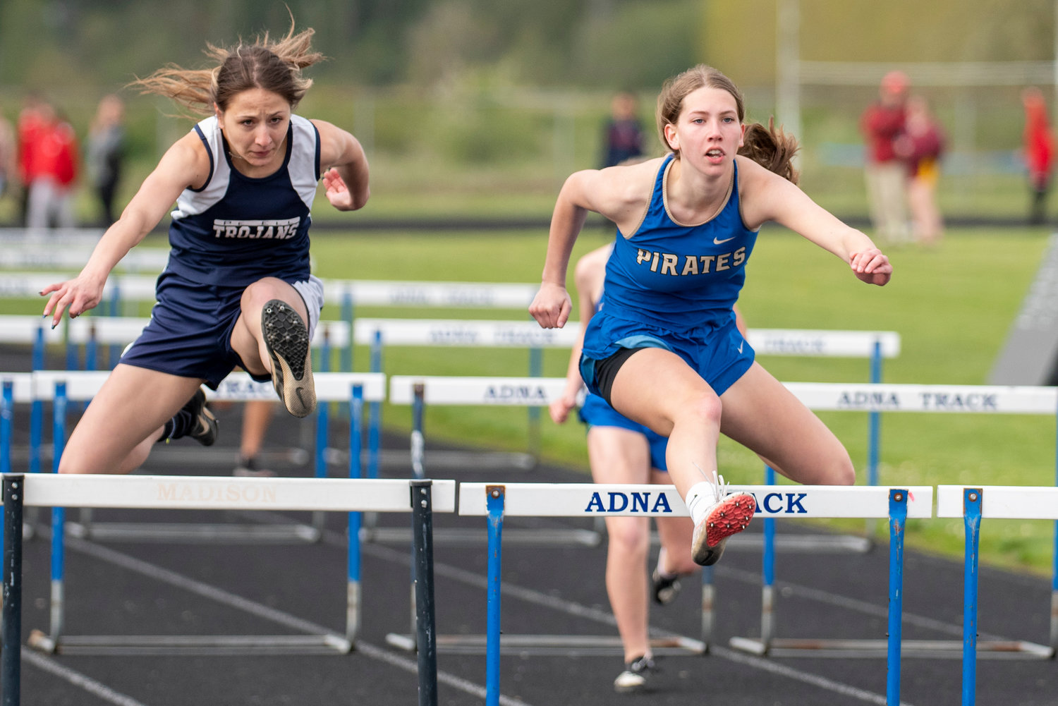 Adna's Faith Wellander, right, and Pe Ell's Charlie Carper clear the final hurdle in the girls 100-meter hurdles during the annual Pirate Classic at Adna High School on Tuesday, May 3.