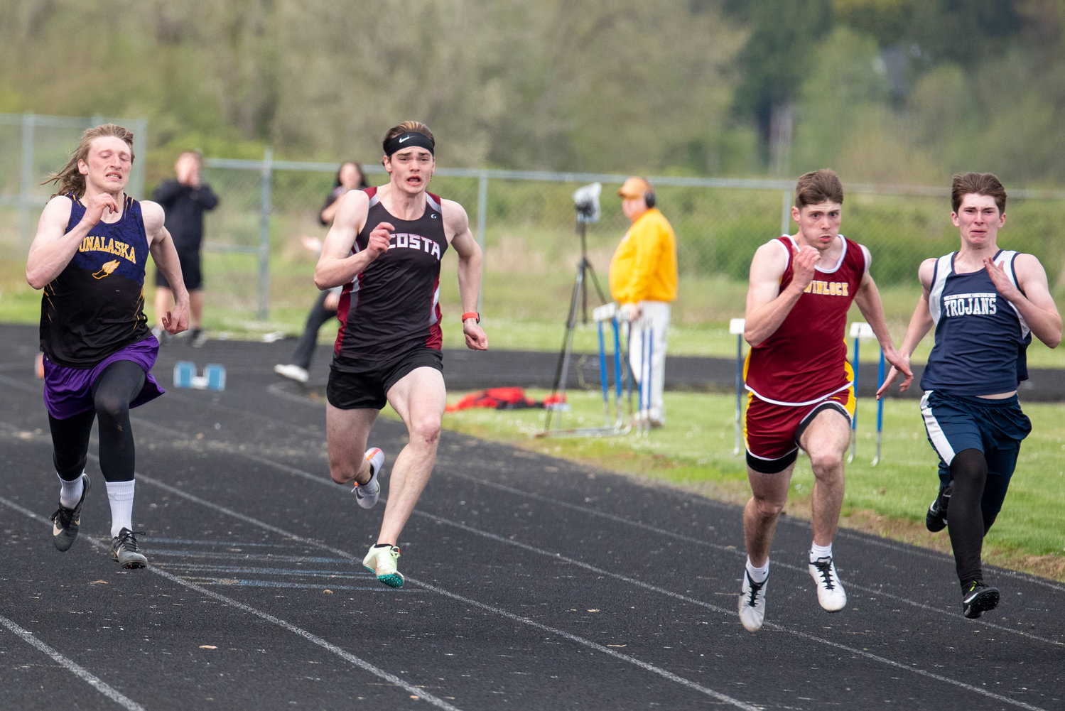 From left, Onalaska's Cole Taylor, Ocosta's William Idso, Winlock's Payton Sickles and Pe Ell's Carter Phelps race in the boys 100-meter dash on May 3. Sickles won the event.