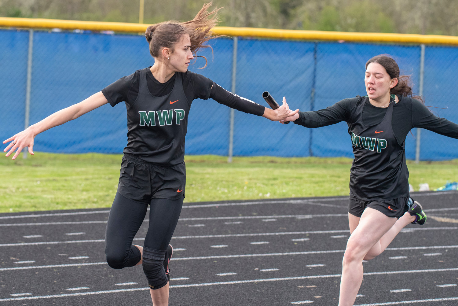 Morton-White Pass' Katelyn Gilstrap, right, hands off to Jordan Koetje in the girls 4x100 relay on May 3. MWP won the event.