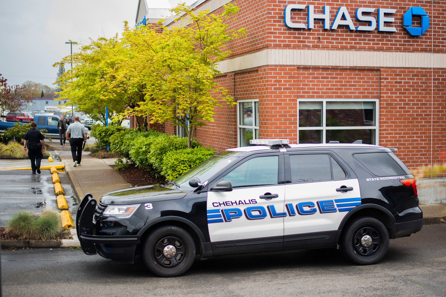 Police officers and vehicles are seen outside Chase Bank in Chehalis on Friday.