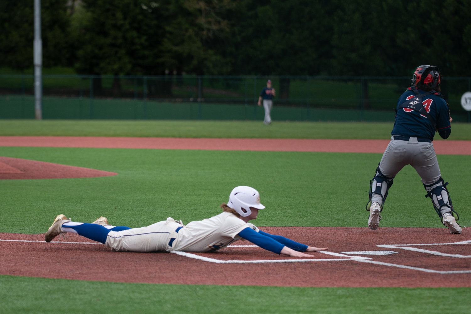 Rochester's Braden Hartley slides home against Black Hills in a play-in game at the Regional Athletic Complex in Lacey May 6.