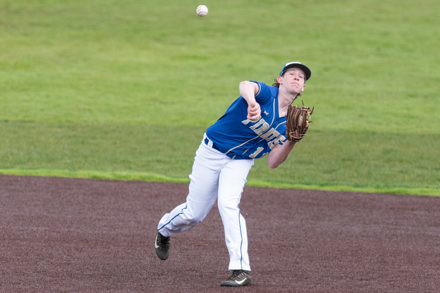 Adna's Chance Muller throws an out at first against Forks in the District 4 quarterfinals at Shelton High School May 7.