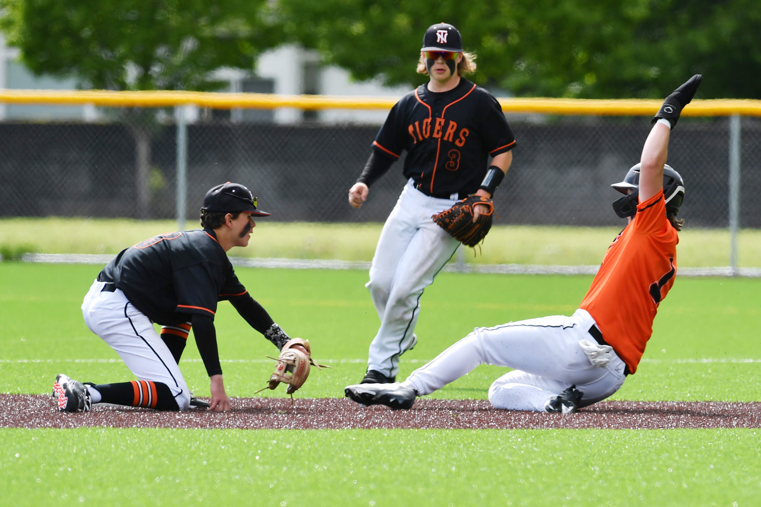 Napavine shortstop Gavin Parker, left, tags a Kalama runner during a district-playoff win on Saturday, May 7.