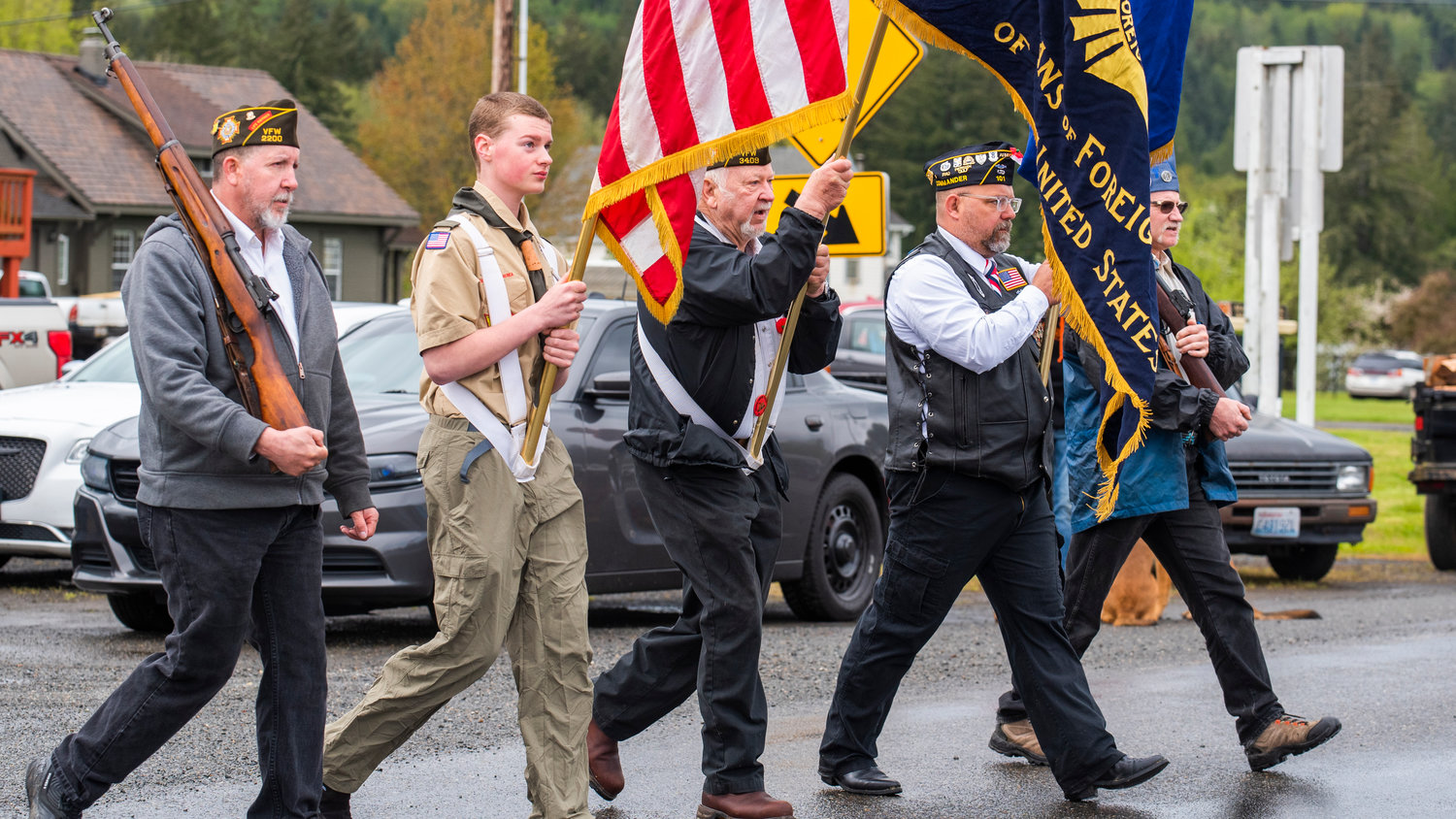 A color guard leads the Vader May Day Parade with flags and rifles on display Saturday morning.