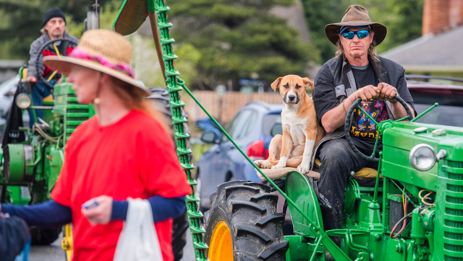 Jerry Andersen rides alongside Razz, his Pitbull-Heeler, while atop a John Deere tractor during the Vader May Day Parade Saturday morning.