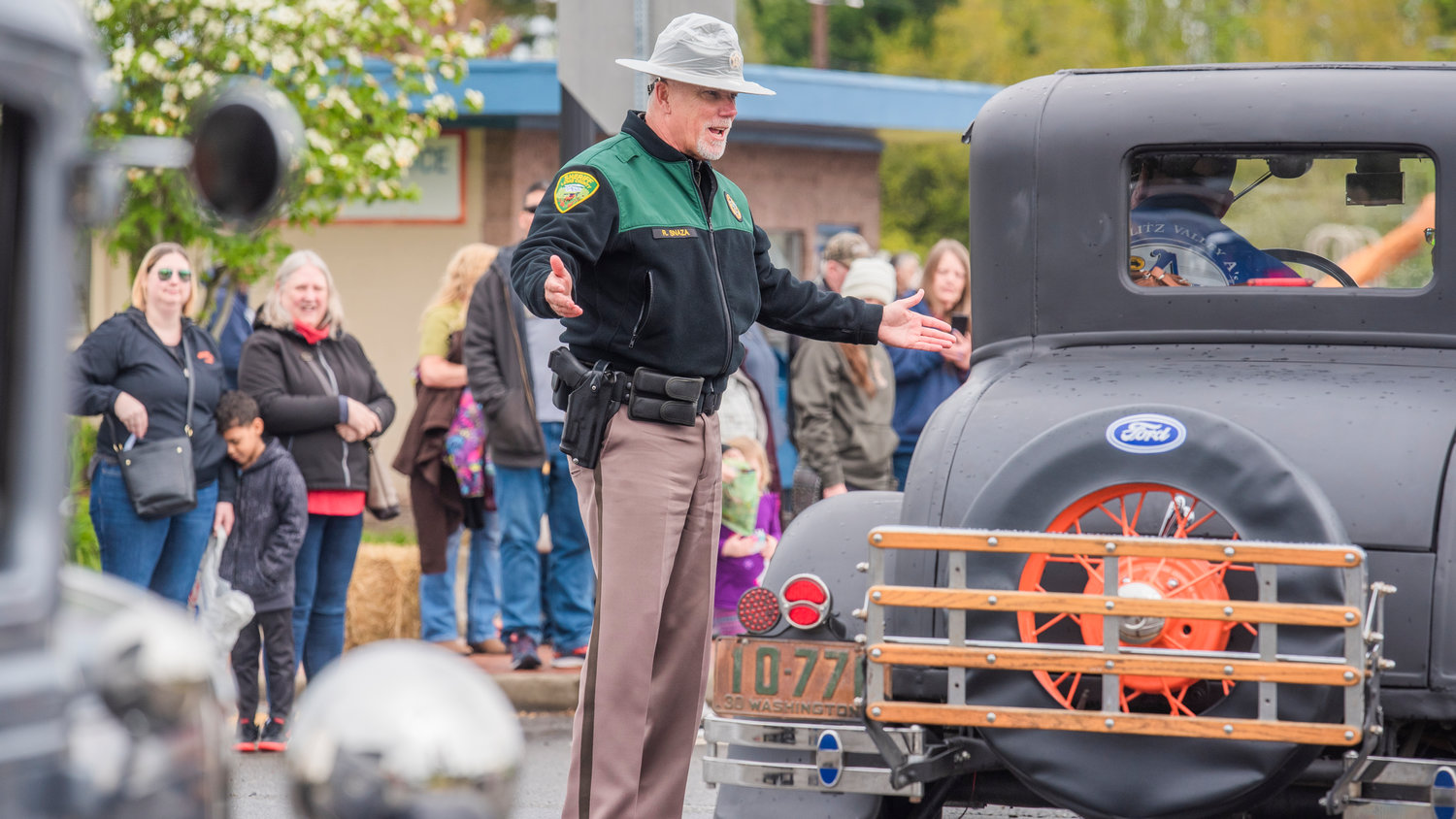 Sheriff Rob Snaza smiles while talking to drivers of vintage vehicles during the Vader May Day Parade Saturday morning.
