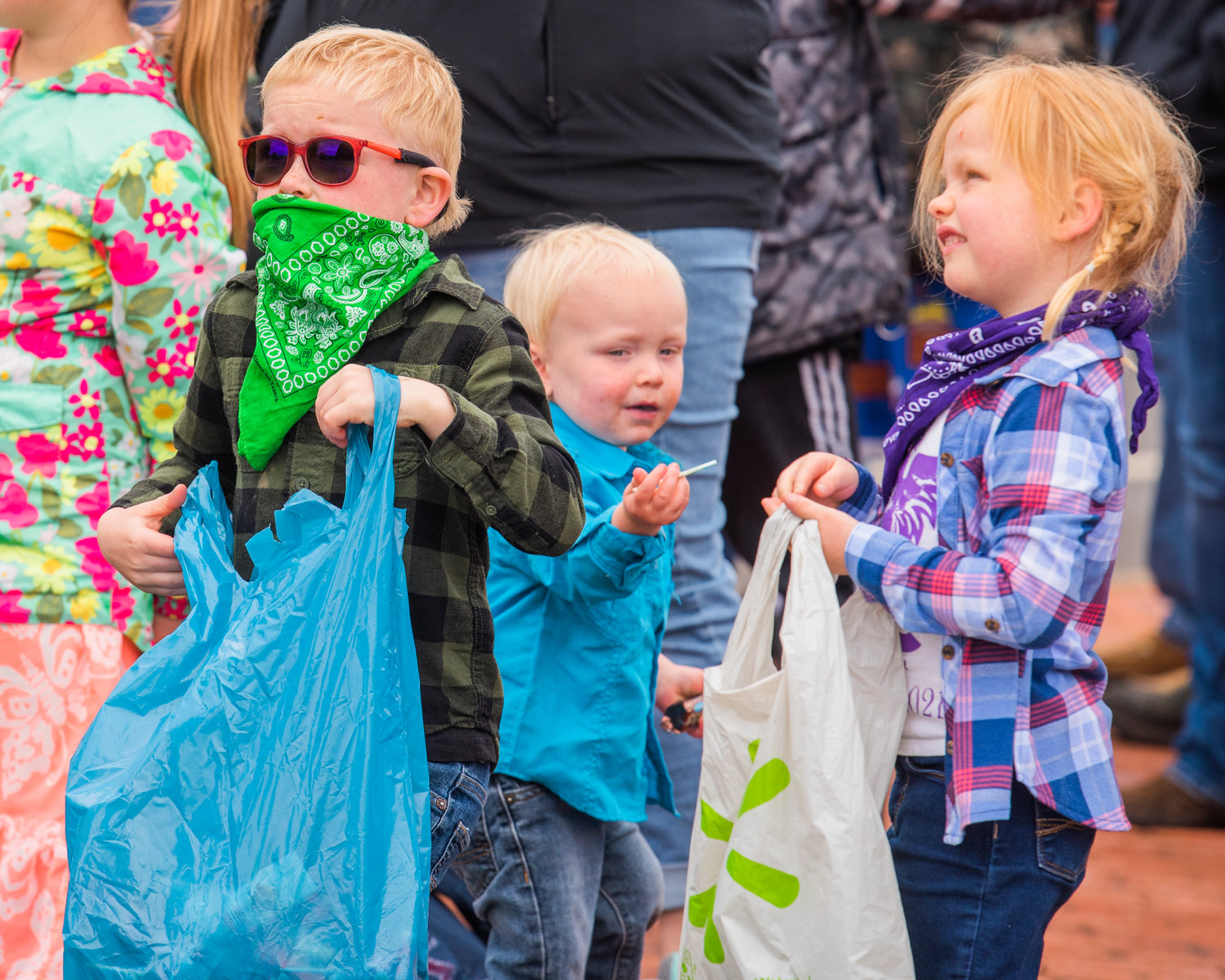 Kids sport bandanas and hold bags of candy during the Vader May Day Parade Saturday morning.