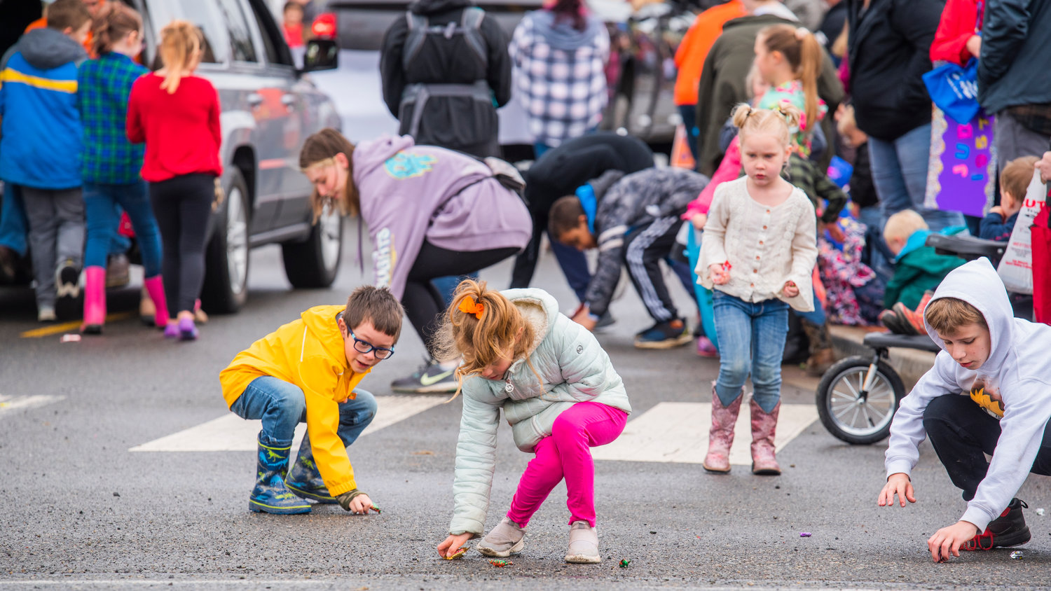 Kids reach for candy during the Vader May Day Parade Saturday morning.
