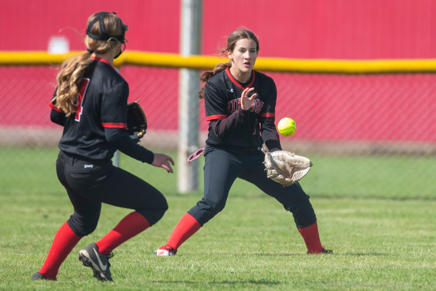 Mossyrock centerfielder Lois Stone, right, fields a Naselle base hit during a win over the Comets on May 9.