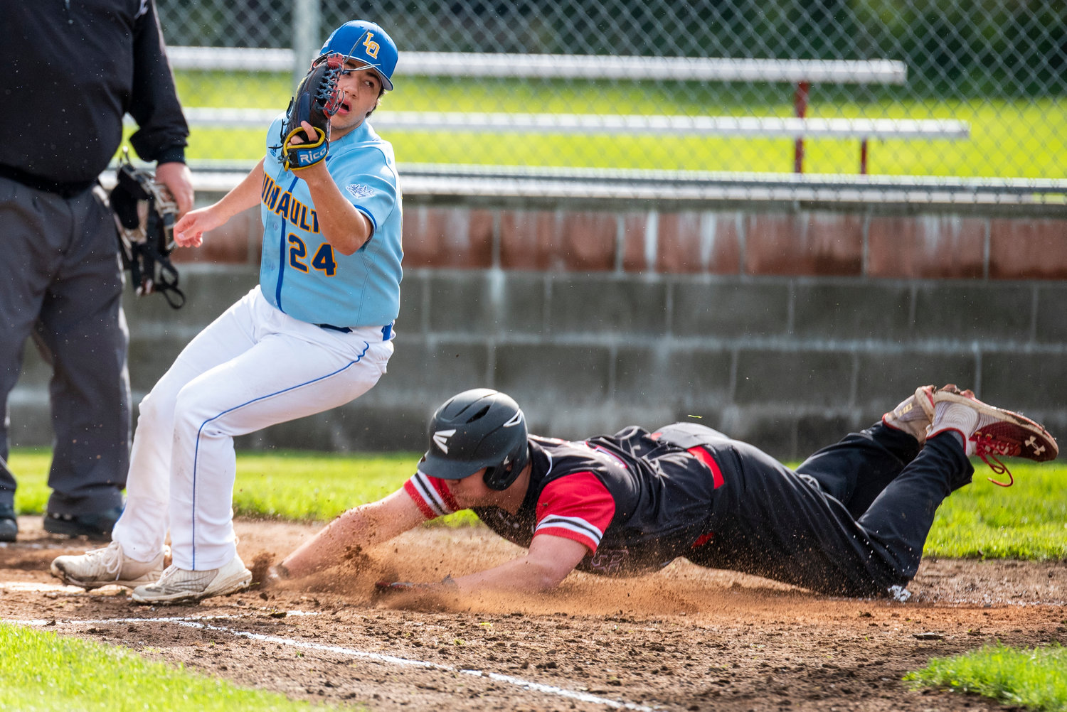 Mossyrock's Andrew Bender slides safely into home plate during a win over Lake Quinault on May 9.