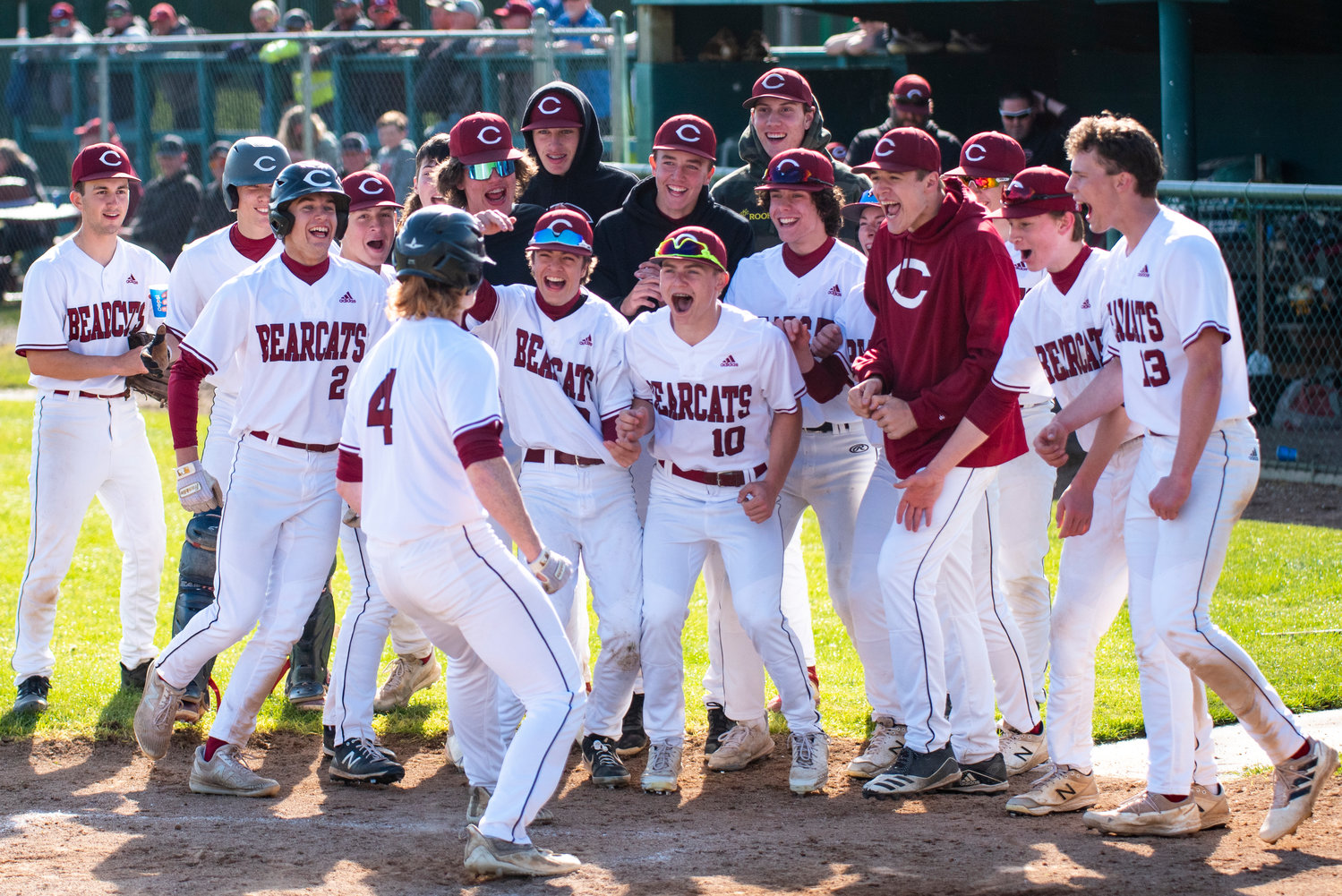 W.F. West baseball meets senior Logan Moore at home plate after Moore hit a home run in the fourth inning of the Bearcats' 11-1 win over Ridgefield in a 2A District IV opener at home on Tuesday, May 10.