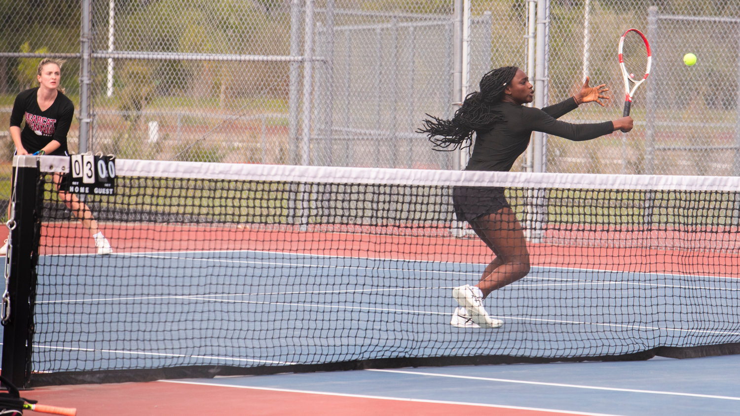 W.F. West’s Mariama Ceesay looks to return a shot at the net in front of her partner Kaylynne Dowling during a doubles match at A.G. West Black Hills High School Tuesday afternoon in Tumwater.
