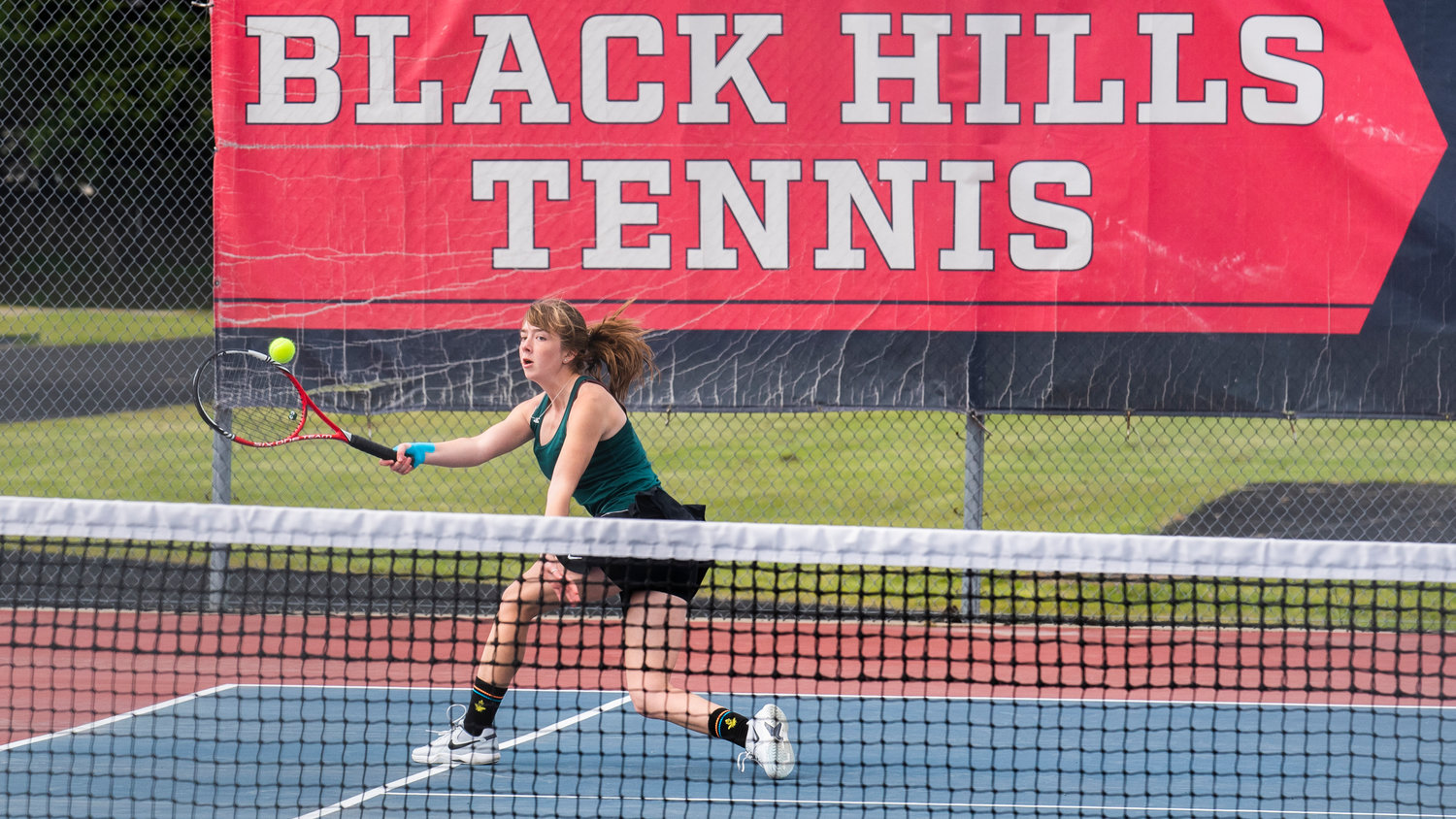 Centralia’s Liza Hopkins stretches out in an attempt to return a shot during a doubles match at A.G. West Black Hills High School Tuesday afternoon in Tumwater.