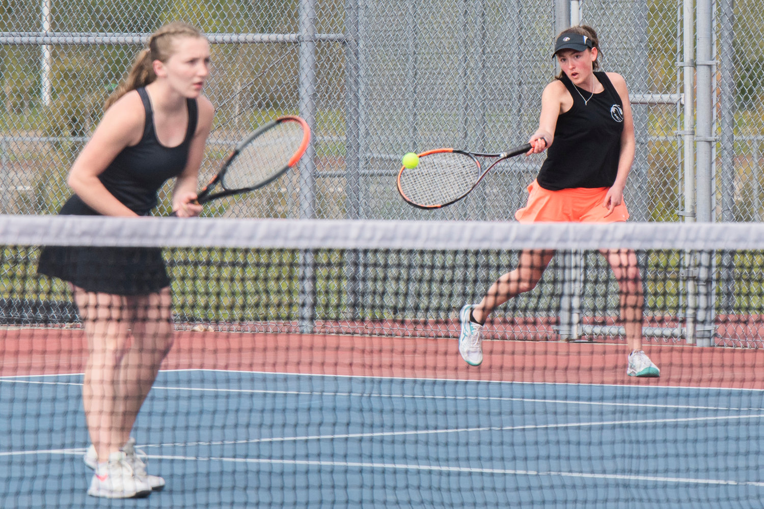 Maya O’Dell, second doubles player for Centralia, looks to return a shot alongside her partner Sophia Stehr during a doubles match at A.G. West Black Hills High School Tuesday afternoon in Tumwater.