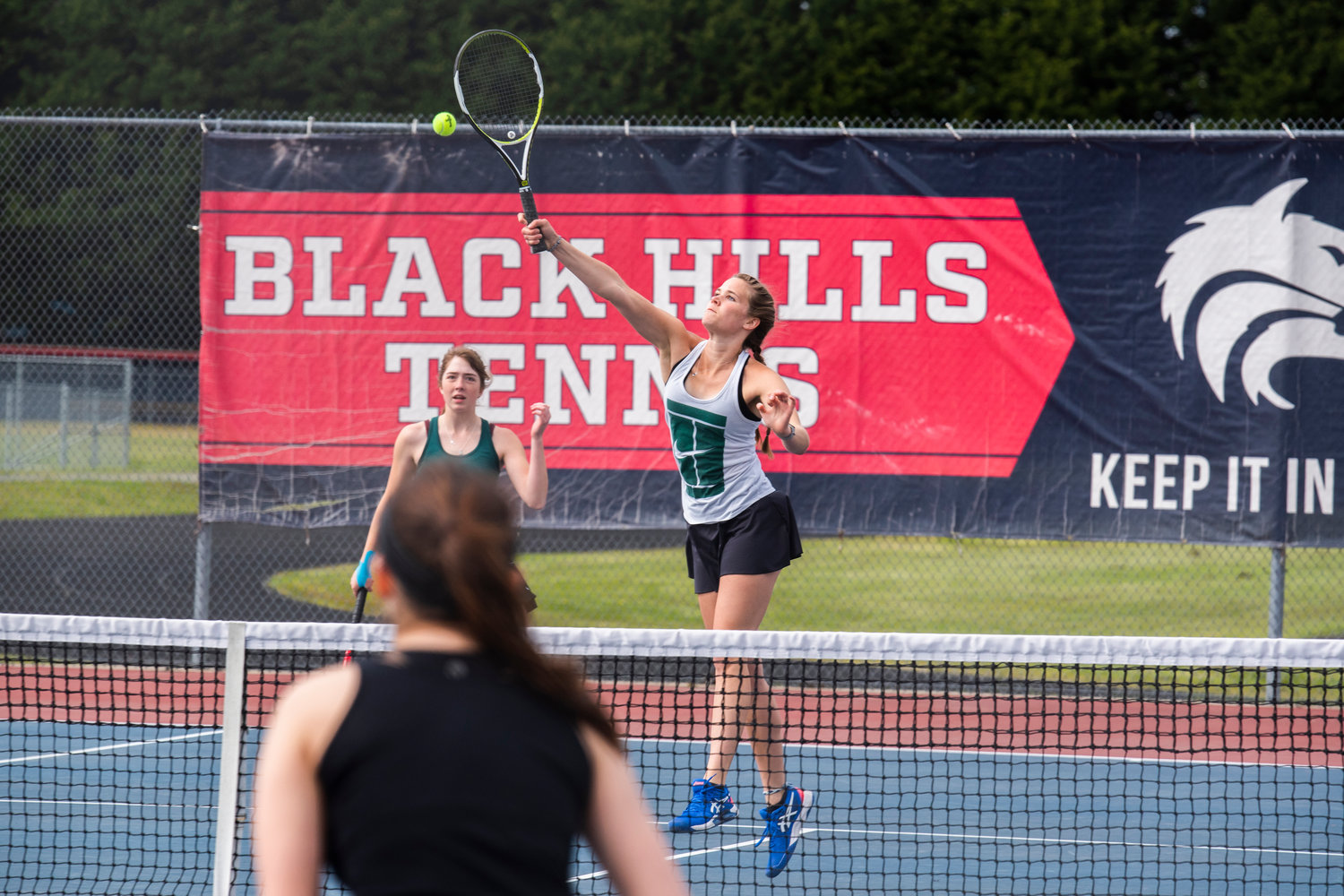 Centralia’s Maddie Corwin goes up for the ball alongside her partner Liza Hopkins during a doubles match at A.G. West Black Hills High School Tuesday afternoon in Tumwater.