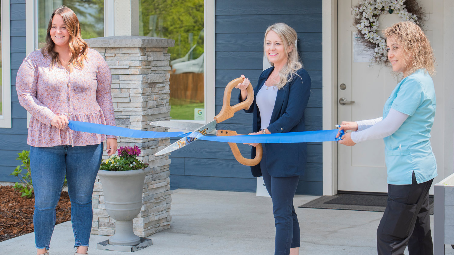 From left, Resident Care Manager Jahnel Otten, Owner RN Danae Elsner, and Caregiver Rosa Mejia smile and pose during a Centralia-Chehalis Chamber of Commerce Ribbon Cutting event at Silver Acres Adult Family Home in Chehalis on Wednesday.