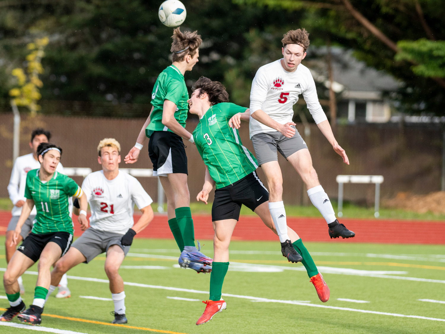 A group of Tumwater and W.F. West players leap for a header on a corner kick near Tumwater's goal during the district semifinals on May 12.