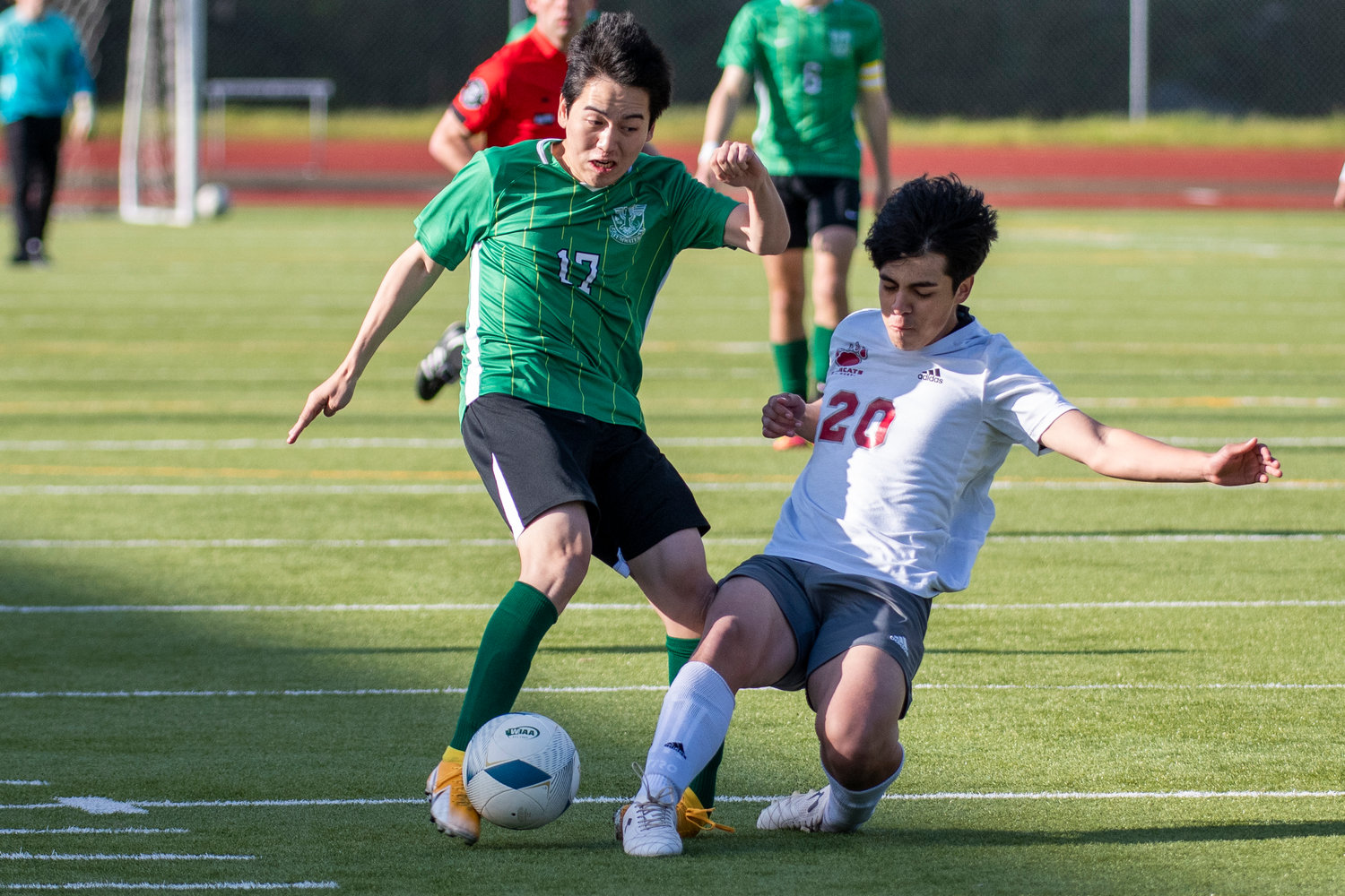 Tumwater's Koki Shibata (17) and W.F. West's Xavier Flores (20) battle for possession during the district semifinals on May 12.