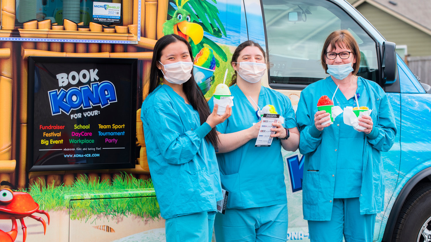 Kristine Wong, Amanda Coverdale and Sherry Zumbuhl pose for a photo in front of a Kona Ice truck Wednesday afternoon outside Providence Centralia Hospital during a caregiver appreciation event.