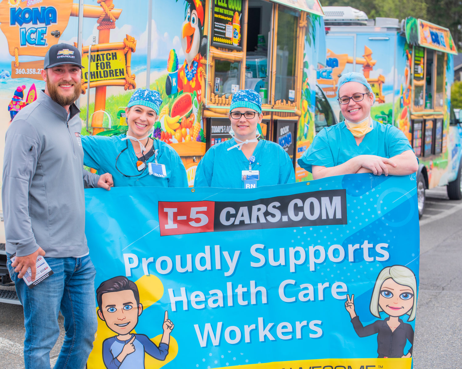 From left, Collin Patterson of I-5 Cars, smiles and poses for a photo with Callie Luond, Alisha Ferch and Kristine Hope at Providence Centralia Hospital in front of a Kona Ice truck Wednesday afternoon during a caregiver appreciation event.