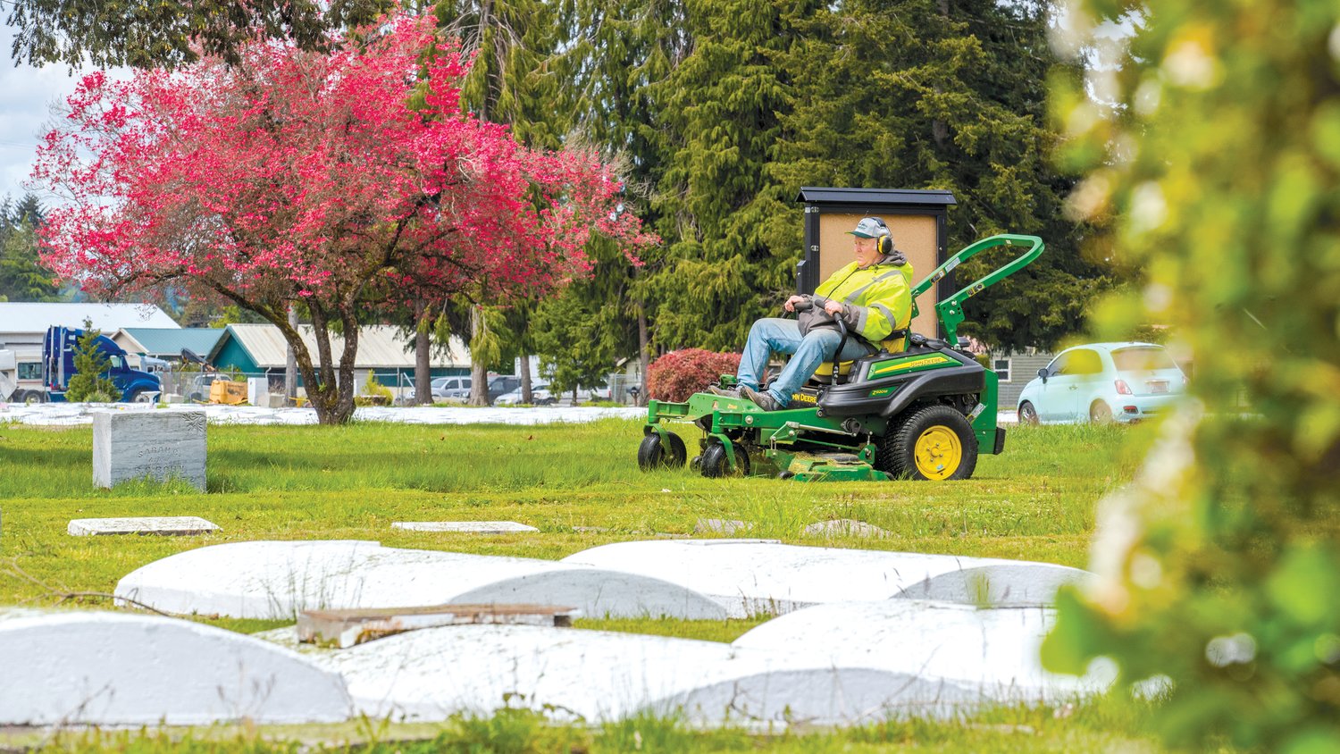 Tim O’Hara mows grass at the Greenwood Memorial Cemetary in Centralia on Friday. O’Hara lives in Olympia and has worked for the Centralia Parks Department for approximately 30 years.
