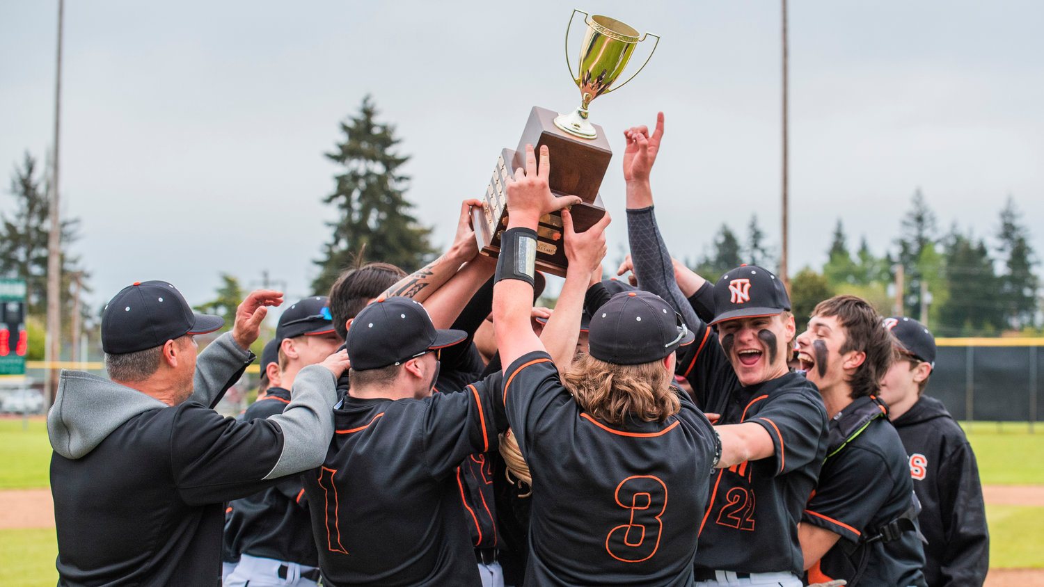 Napavine Tigers hold up a trophy and celebrate after defeating Toutle Lake for the 2B District 4 Title Friday at W.F. West in Chehalis.