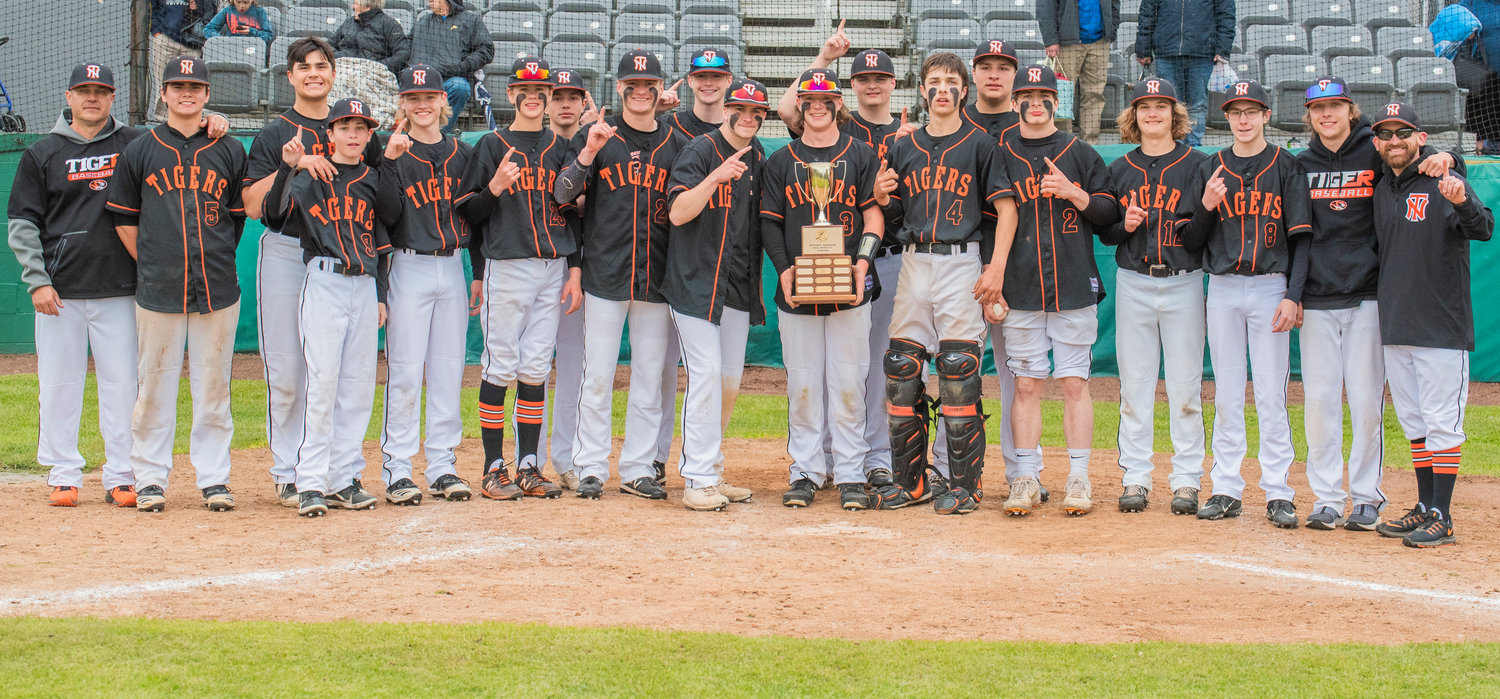 Napavine Tigers smile and pose for a photo with the 2B District 4 trophy after defeating Toutle Lake Friday in Chehalis.