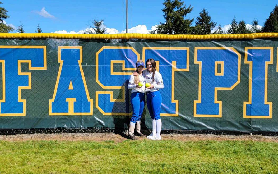 Sisters Layna and Kaylee Demers pose with home run balls after each going yard in Rochester's doubleheader sweep of Aberdeen May 14.