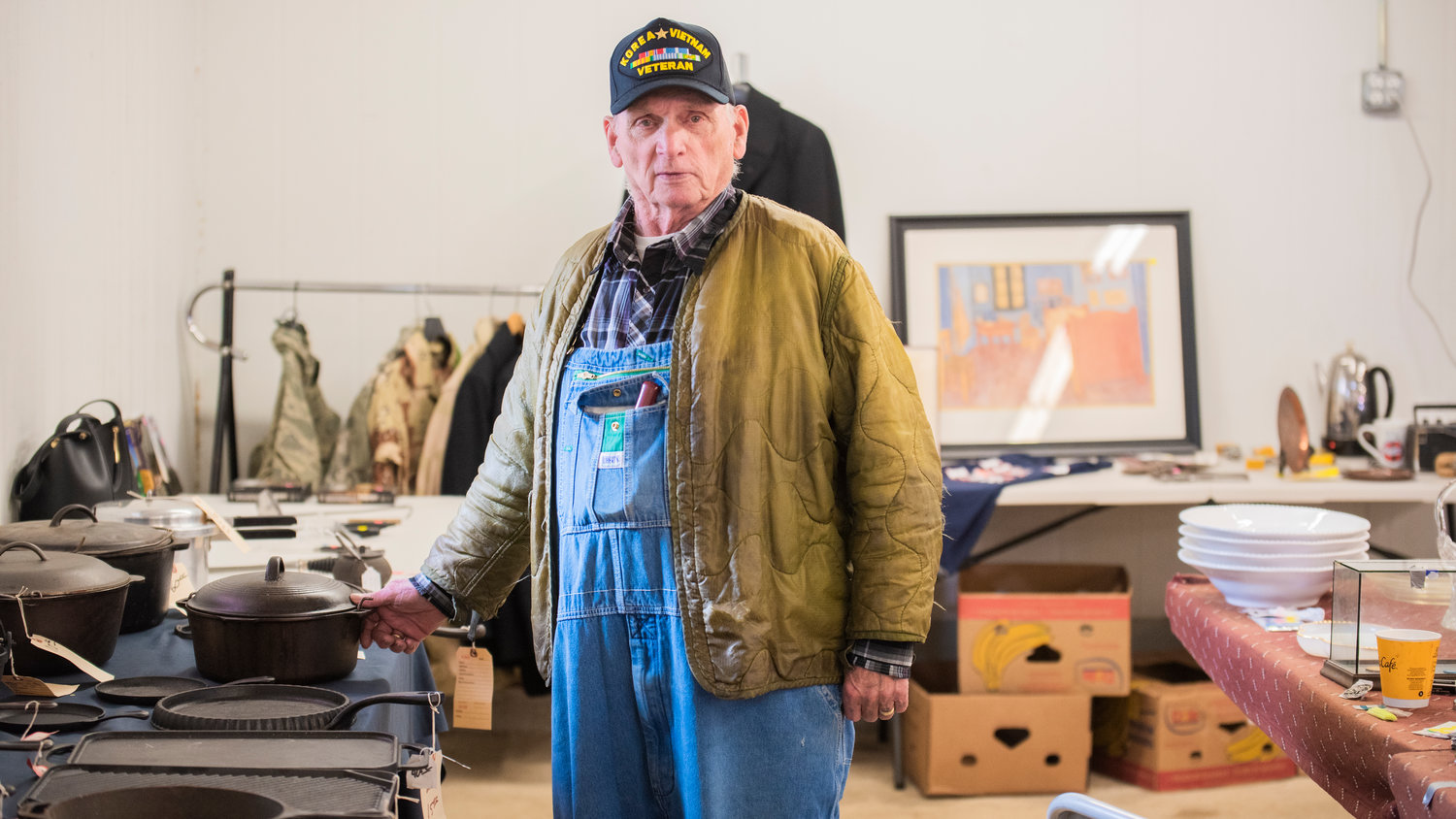 Burt Illig, 88, stands between fellow salesmen John Sheilds and Vern Webb during the Spring Community Garage Sale Saturday morning in Centralia. Illig, a Navy Veteran, specializes in cast iron cookware.