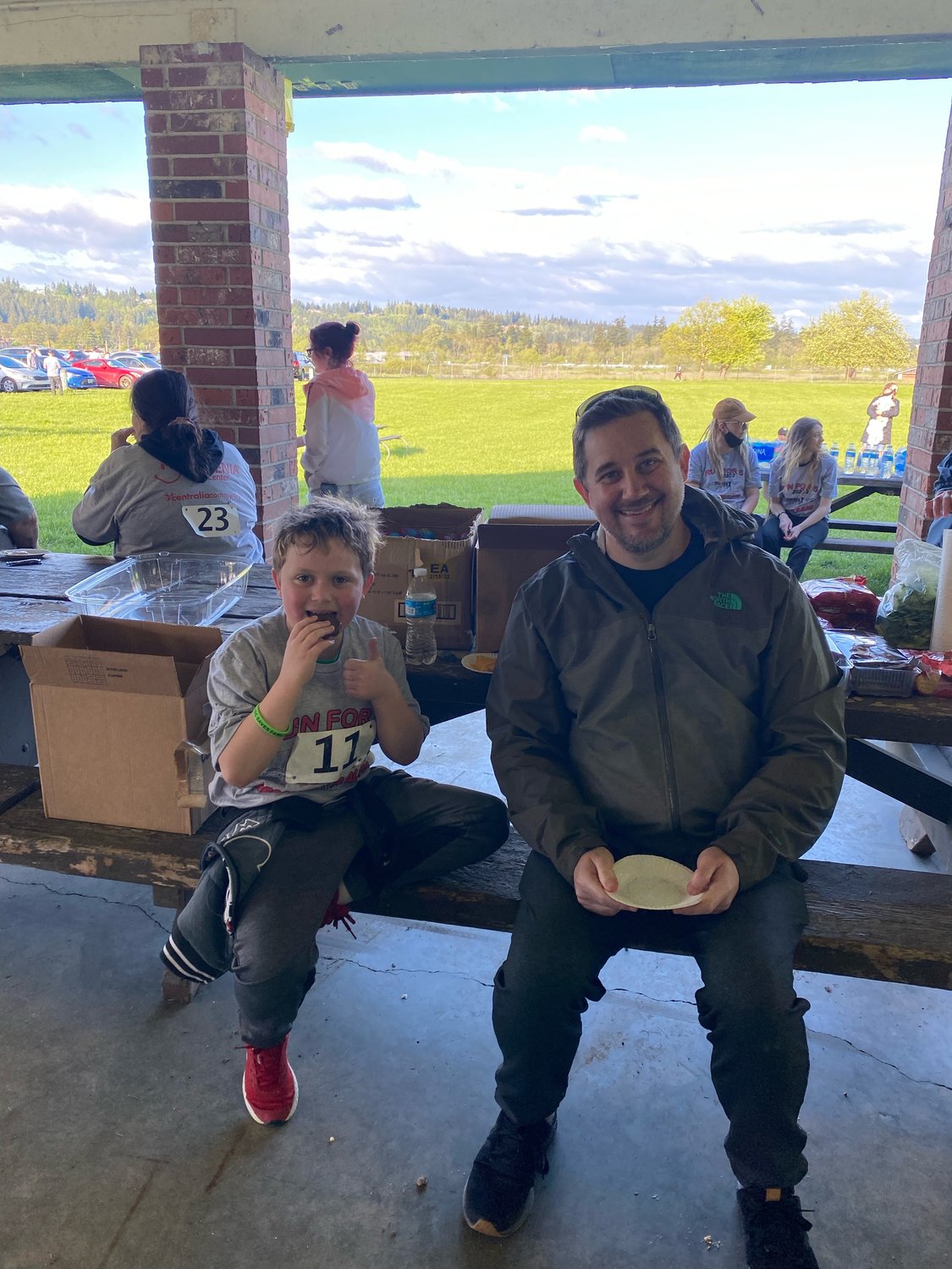 Sam and Jaxson Groberg eat lunch at the Run for Five, Recovery is Alive 5k in Chehalis on Monday.