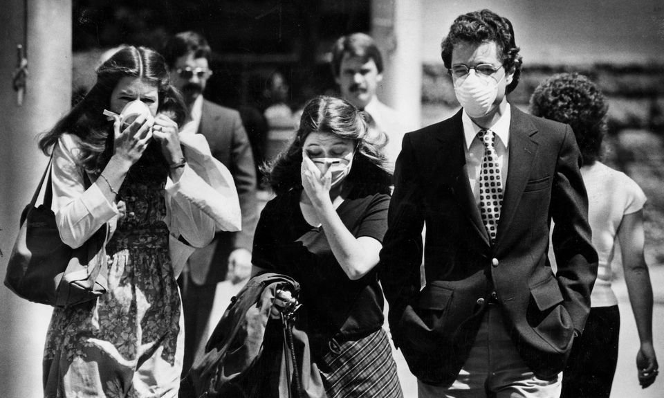 Portlanders on Southwest Fifth Avenue wear the latest fashions -- masks -- as volcanic ash swirls through Portland streets after the eruption of Mount St. Helens. (The Oregonian)