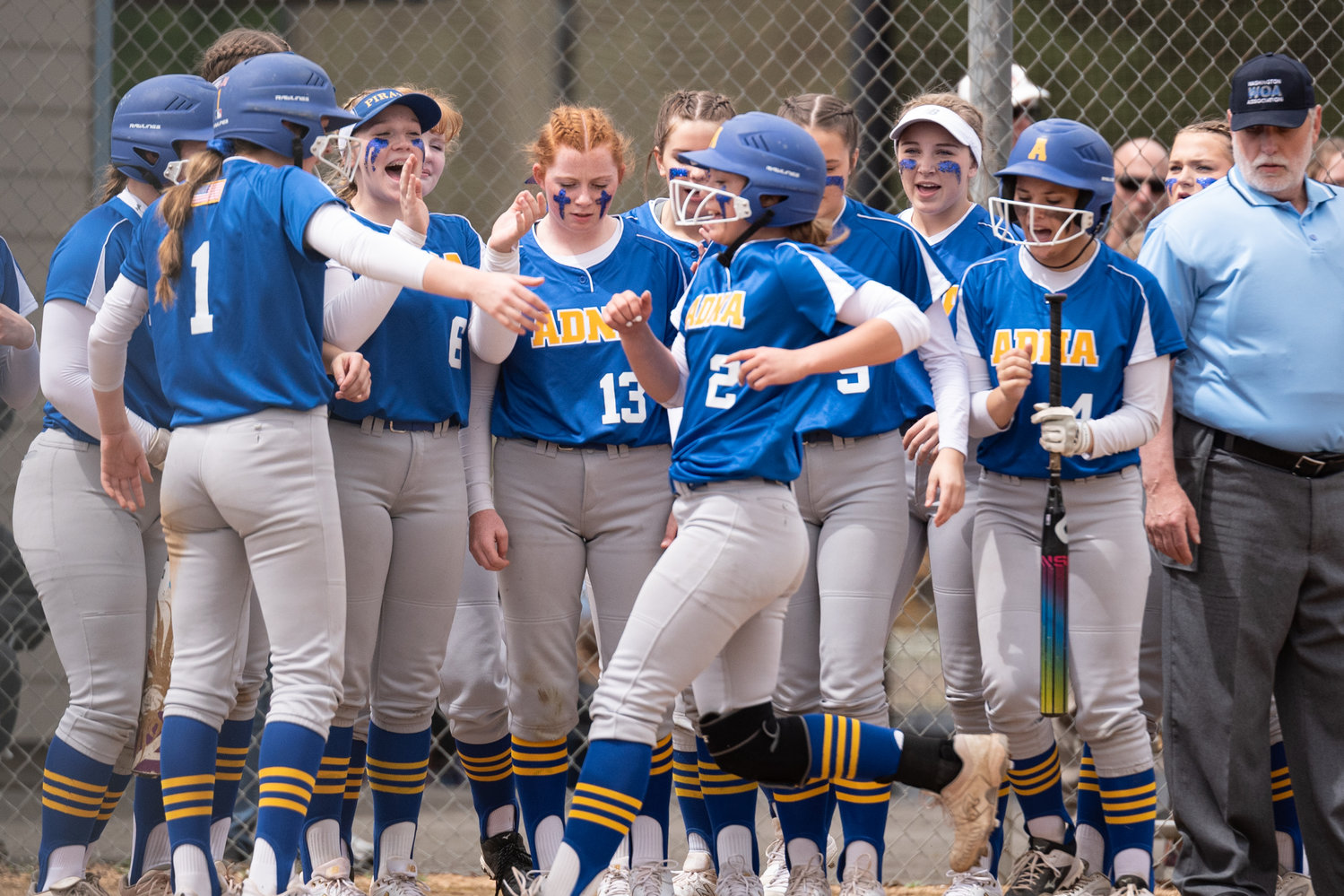 Adna pitcher Ava Simms is greeted at home plate by her teammates after a home run against Toutle Lake in the 2B District 4 tournament at Fort Borst Park May 20.