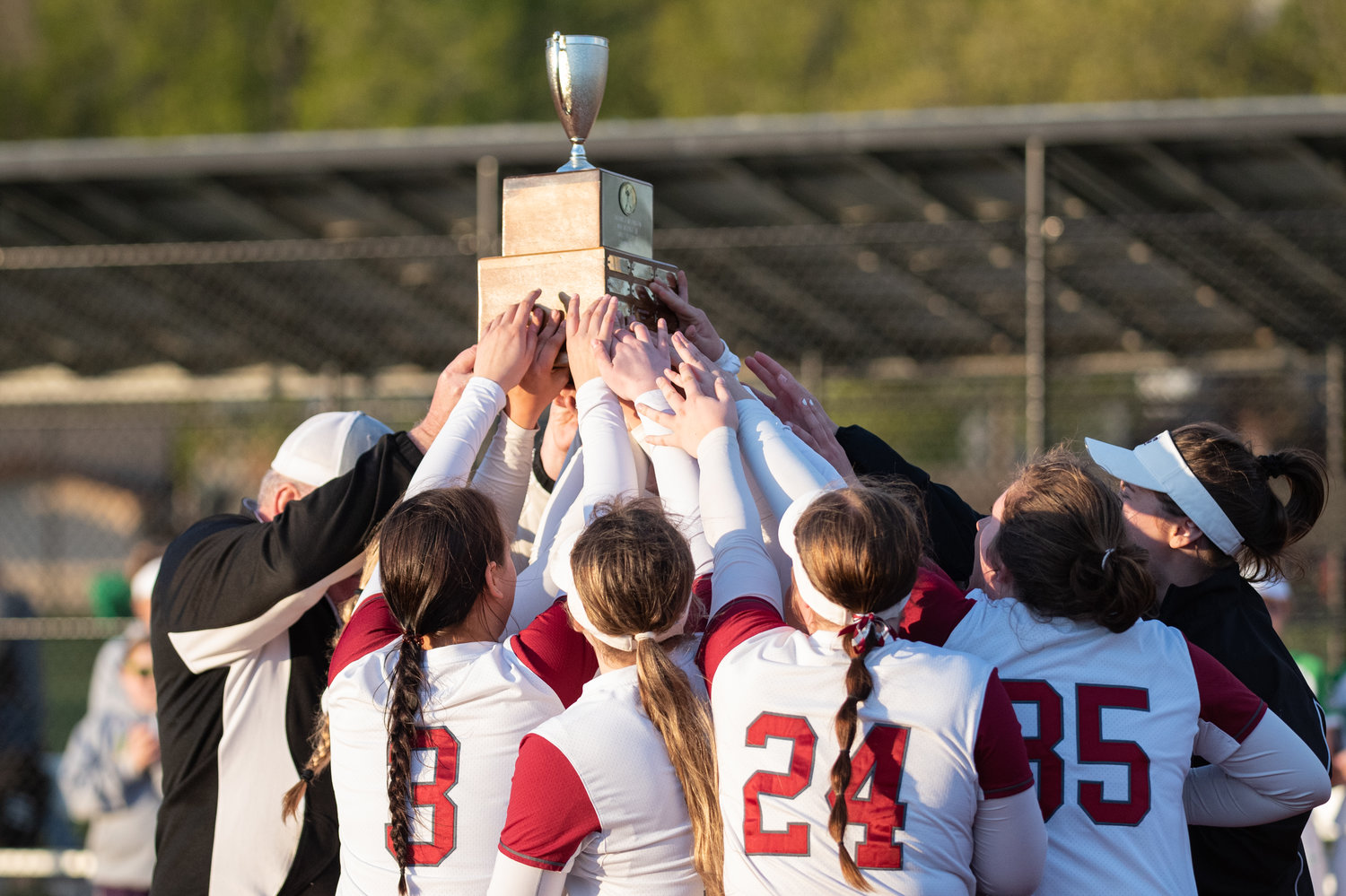 The W.F. West softball team holds up the district championship trophy after defeating Tumwater, 4-2, in the title game at Rec Park May 20.