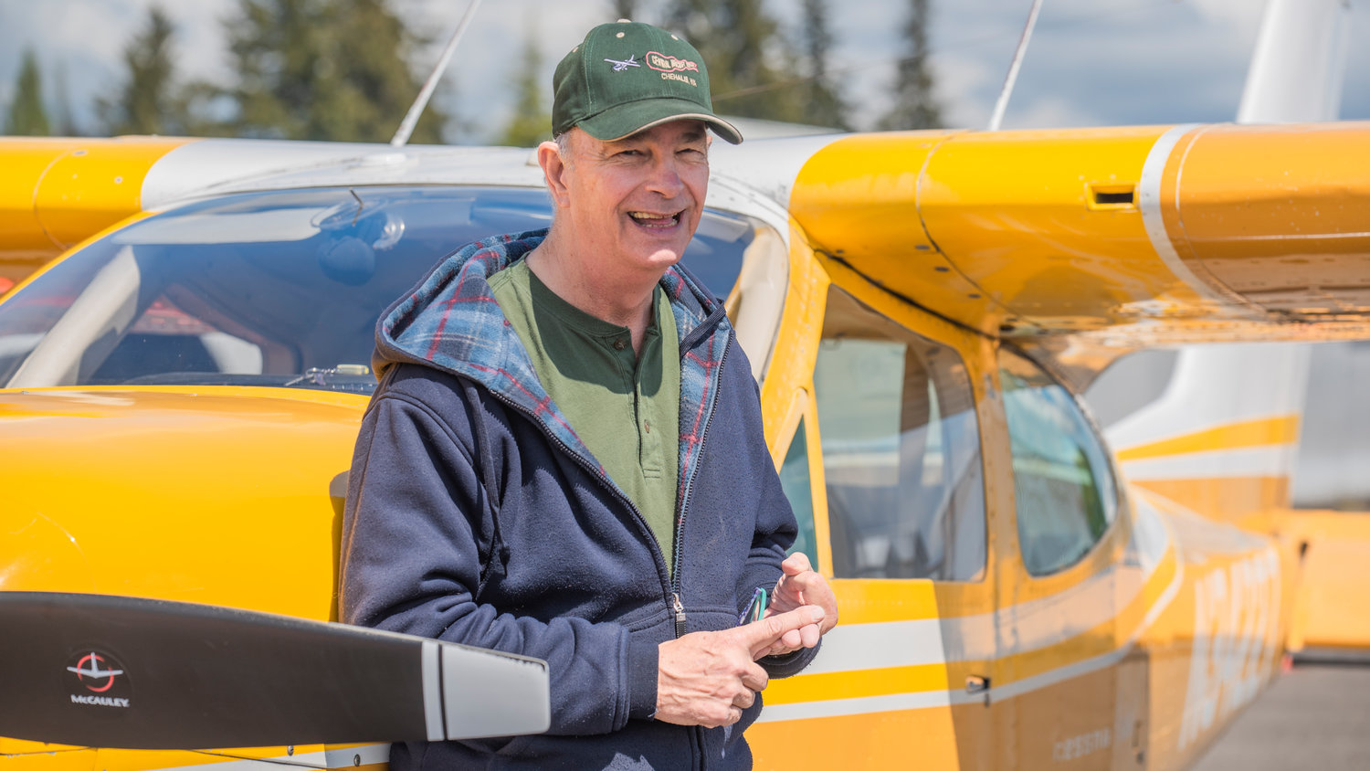Dave Neiser smiles while standing next to his yellow Cessna 177 Cardinal at the Chehalis-Centralia Airport last week.
