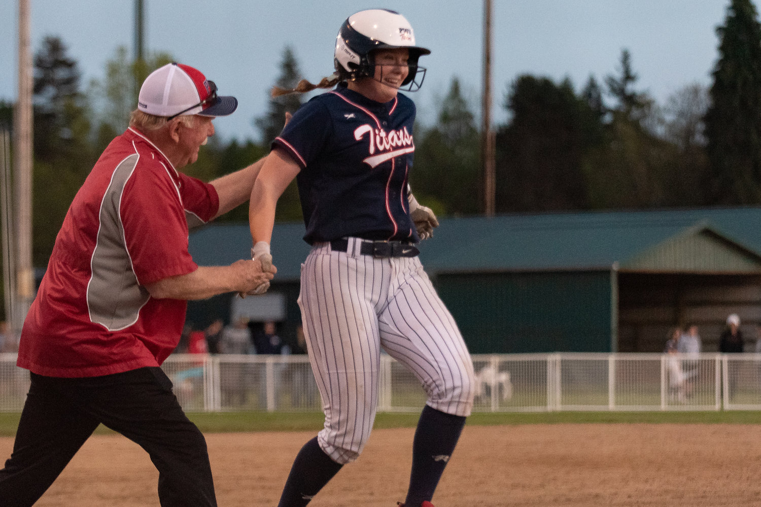 PWV pitcher Olivia Matlock runs to home plate while high-fiving coach Ken Olson after a home run against Adna in the 2B District 4 softball championship game at Fort Borst Park in Centralia May 21.