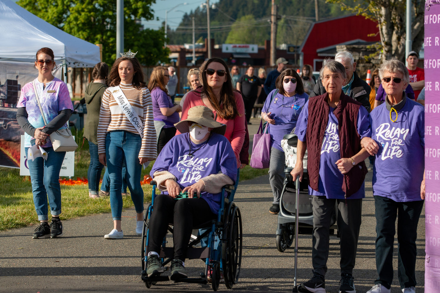 A large group of people start their first lap following the Family of the Year, Kyle and Kara Markstrom, at the Relay for Life event held at the Southwest Washington Fairgrounds Friday evening.