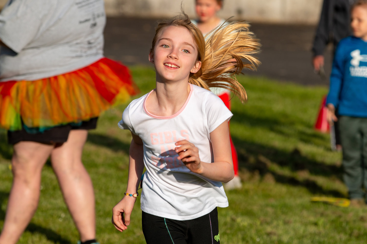 Alison runs to claim her prize during the cake walk at Kelli’s Kids Kamp held at the Relay for Life event at the Southwest Washington Fairgrounds Friday evening.