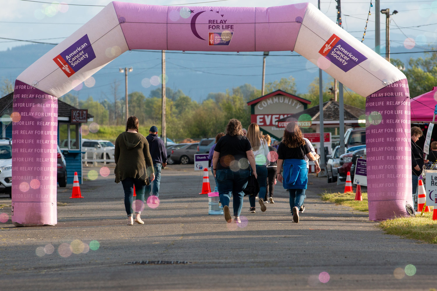 People walk under the starting-point arch at the Relay for Life event held at the Southwest Washington Fairgrounds Friday evening.