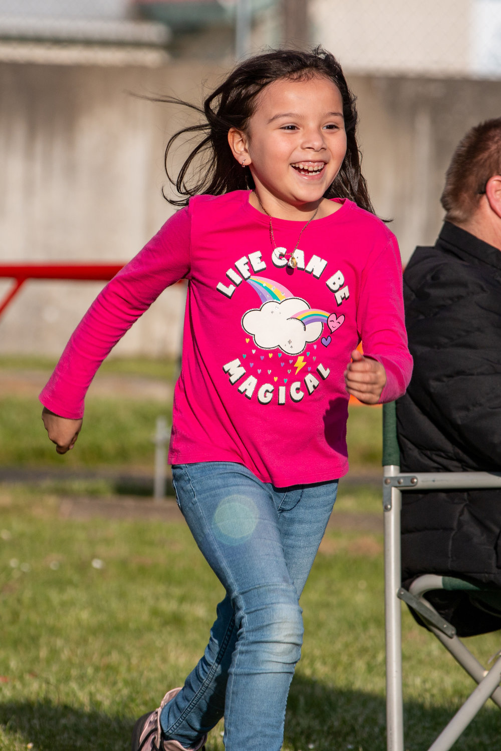Siana Reyes, daughter of Briana and Paco Reyes, excitedly runs to claim her prize at Kelli’s Kid Kamp at the Relay for Life event held at the Southwest Washington Fairgrounds Friday evening.