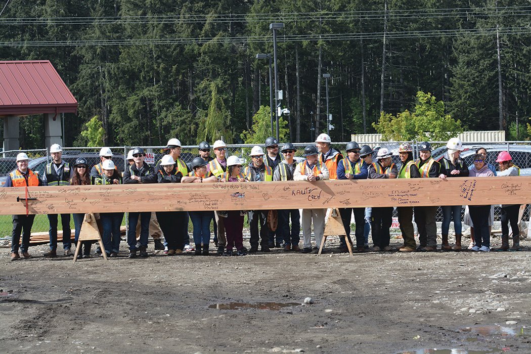 Construction workers pose for a photo prior to the “topping out” ceremony on May 19.