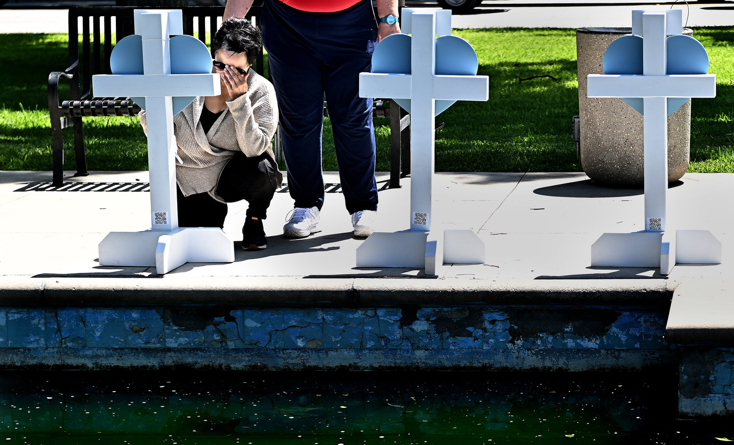 A Robb Elementary school employee named Amy visits a memorial for the victims of a mass shooting in Uvalde, Texas, on Thursday, May 26, 2022. Nineteen students and two teachers died when a gunman opened fire in a classroom Tuesday. (Wally Skalij/Los Angeles Times/TNS)