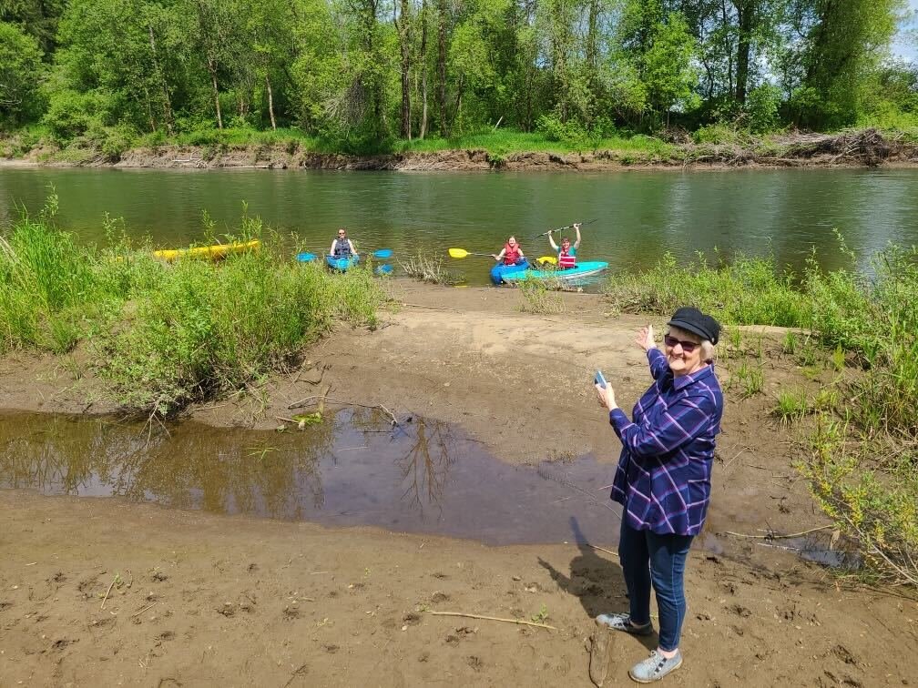 Edna Fund poses for a photo with kayakers along the Chehalis River on Wednesday.