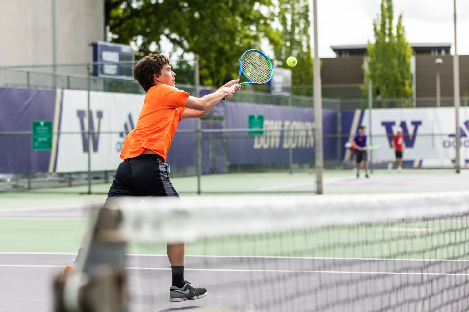 Centralia's Brandon Yeung leans to hit the ball during the first set of the 2A boys' doubles tennis state competition on May 27, 2022.