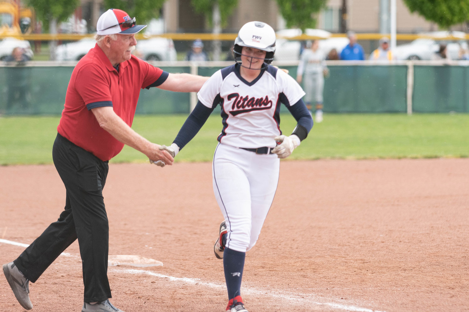 PWV coach Ken Olson sends Olivia Matlock toward home plate after her home run against Adna in the state title game at Yakima Gateway Sports Complex May 28.